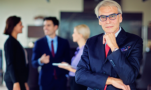 A gray-haired attorney in a law office