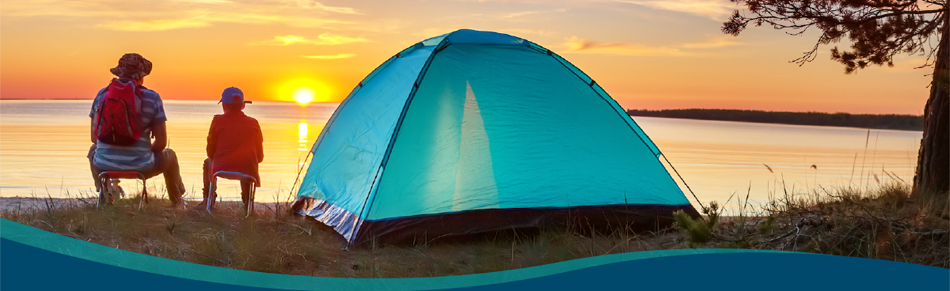 Father and son camping at sunset