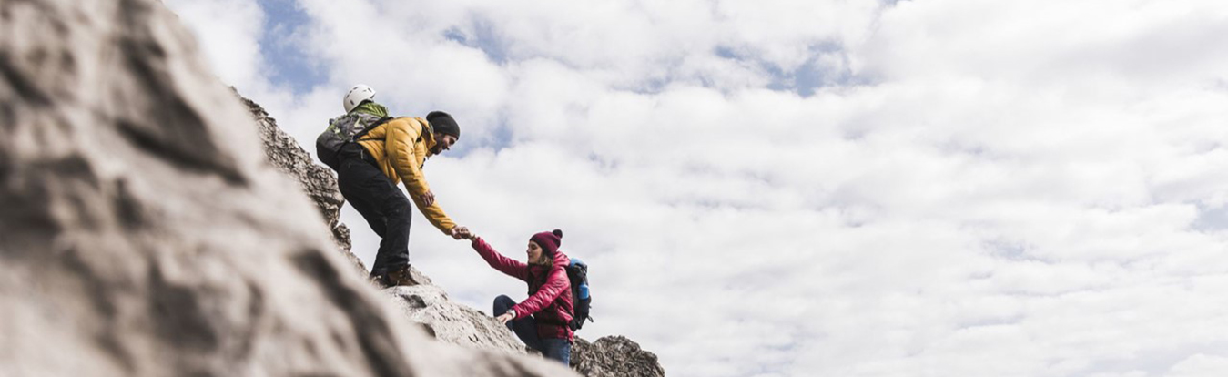Man and woman rock climbing