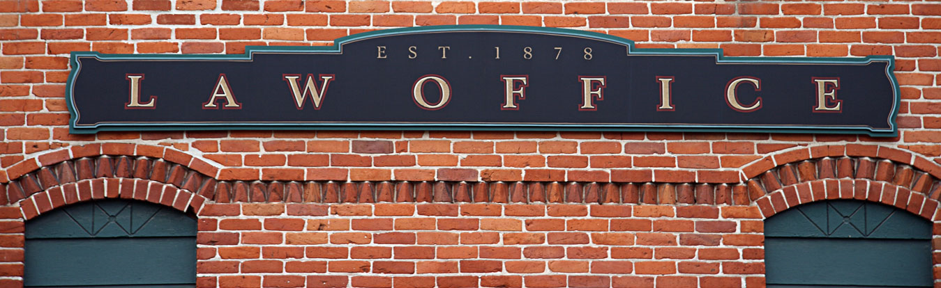 A brick building with a sign that reads Law Office