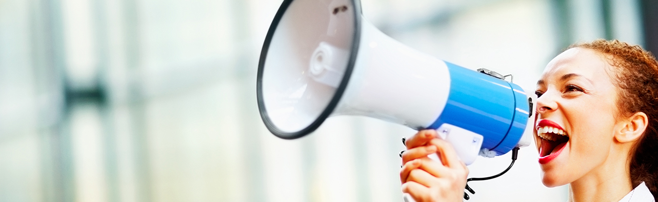Woman yelling through a bullhorn