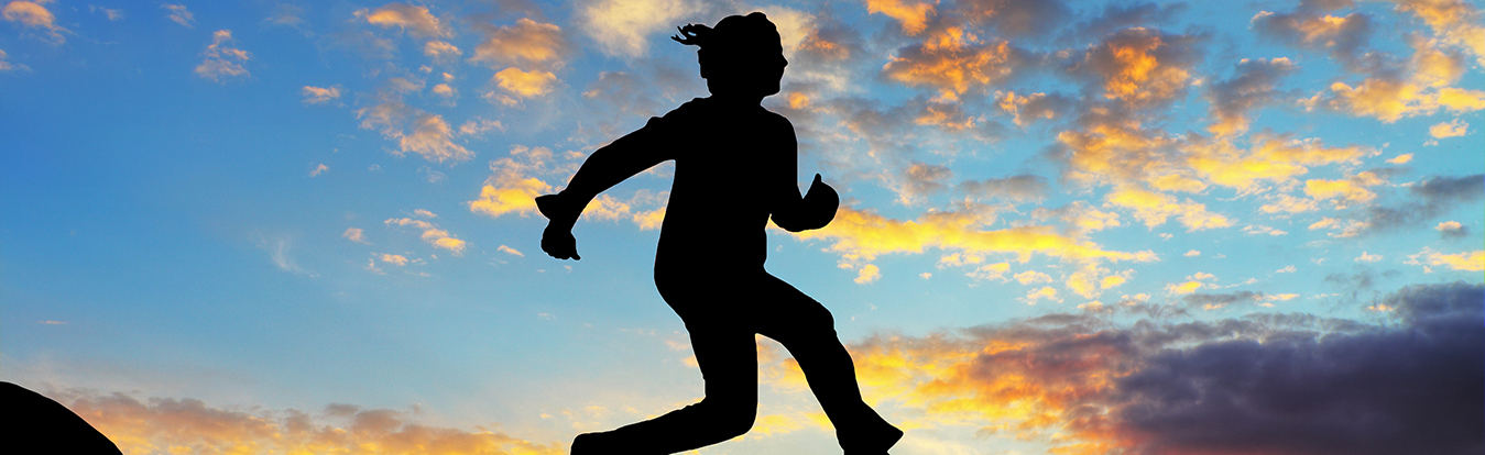 Image of a woman jumping over a chasm