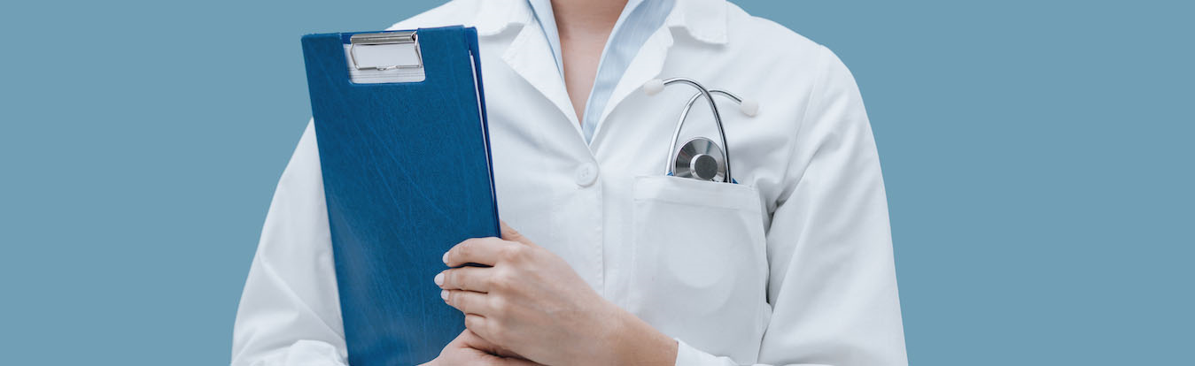 A female medical worker holding a clipboard