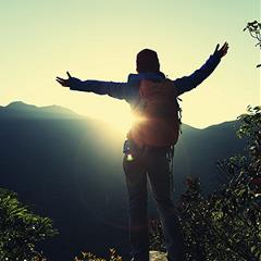 Female climber celebrates at the peak