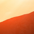 Awomanwalkingupamountain