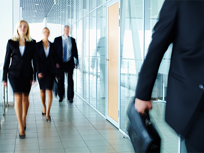 Lawyers walking in firm office.