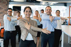 A group of attorneys doing stretching exercises in their office