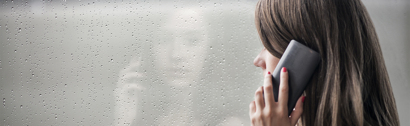 A sad woman talking on the phone